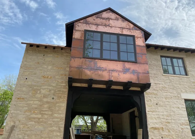 Copper metal panel facade on a stone building for Skylight Installation in Prichard
